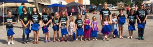 kids lined up at a street fair